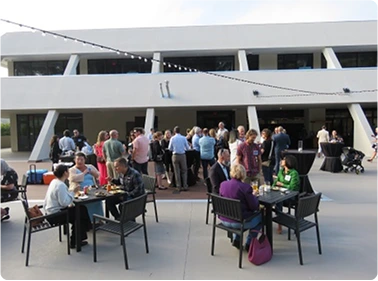 Group photo at community event under branded tent