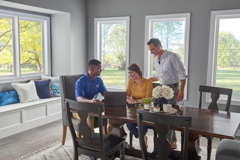 carrier employee talking to a couple in the kitchen