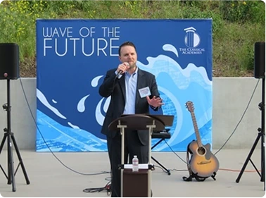 Community outreach display with people gathered outdoors