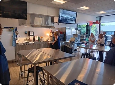 Indoor community event with booth display and attendees