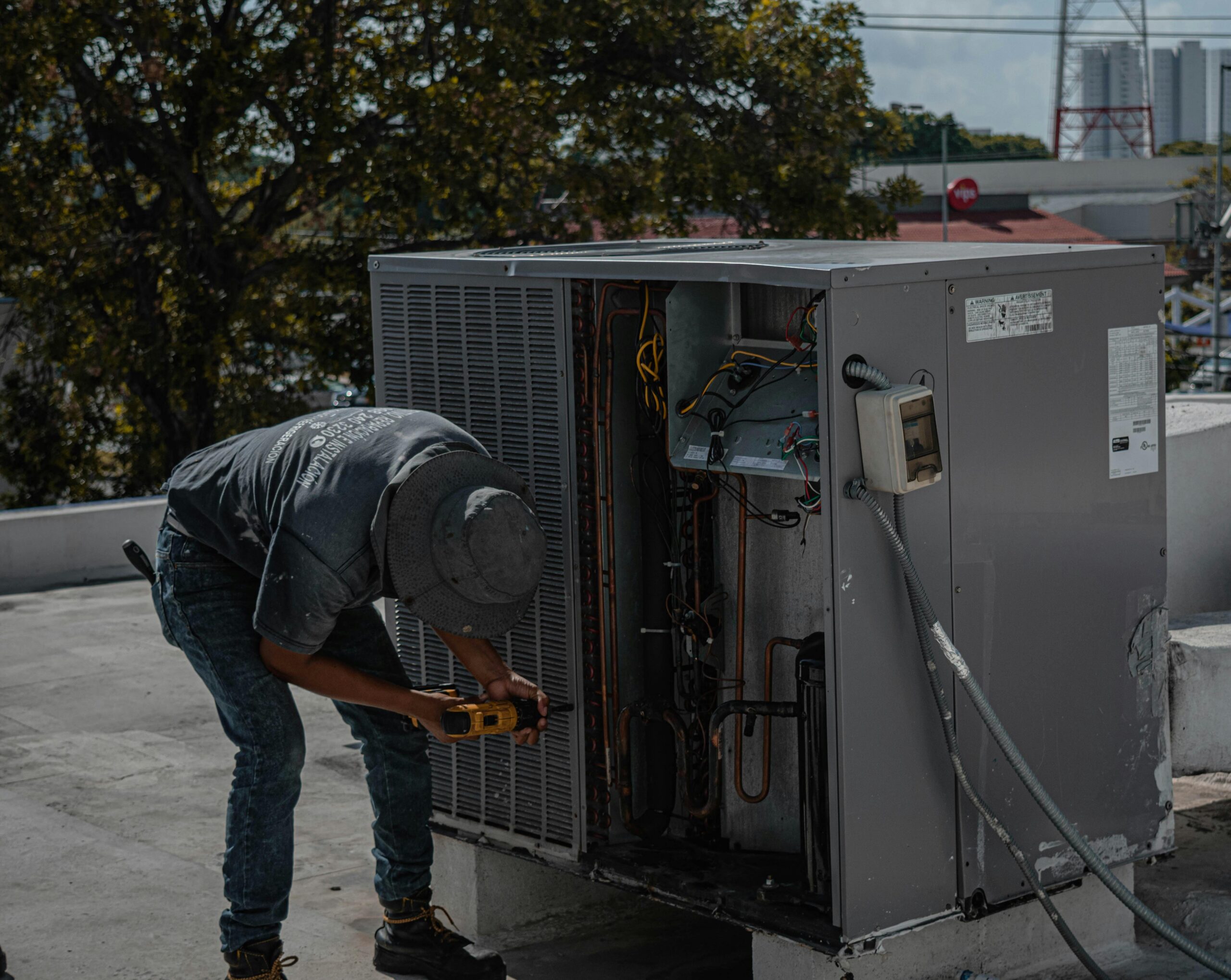 professional technician servicing a commercial rooftop HVAC unit - commercial hvac control rancho bernardo ca